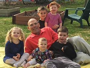 Victor Katch surrounded by his grandchildren.