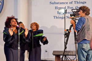 Sacks on set with the Hallelujah Singers