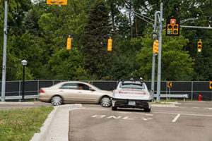 Vehicle-to-vehicle (V2V) communications help a driverless Lincoln avoid a crash