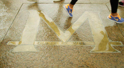 Students cross the Block M on the Diag