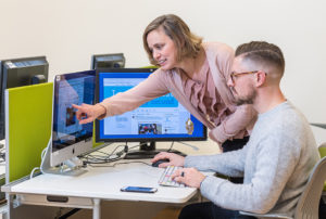 School of Education professor Liz Kolb shows graduate student Conall Walsh how she uses Twitter