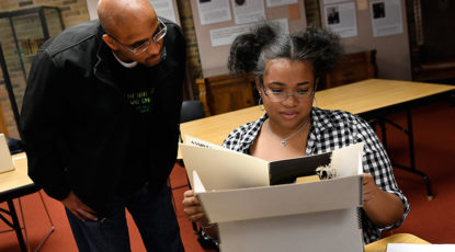 Stephen Ward, associate professor of Afroamerican and African studies, and a student examine archived materials from the Department of Afroamerican and African Studies. The materials have been newly digitized and made available online for U-M students, faculty and staff. (Image: Lon Horwedel)