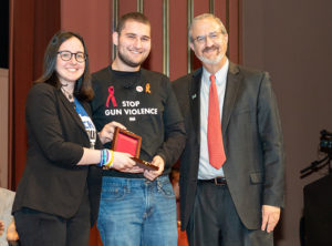 Sofie Whitney and Alex Wind of March For Our Lives receive their group’s medal from Schlissel.