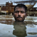 Environmental migrant Razek swims in the Buriganga River in Dhaka, Bangladesh.