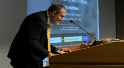 U-M President Mark S. Schlissel conducts the first official search of the new Detroit Jewish News digital archive with the quote, “I felt my legs were praying” on Nov. 5, 2018. (Image: Lon Horwedel.)