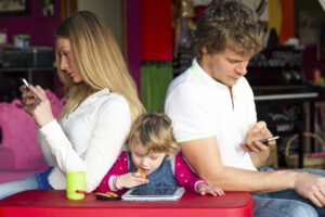 Family on electronic devices, ignoring one another