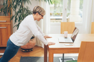 Woman exercises at desk