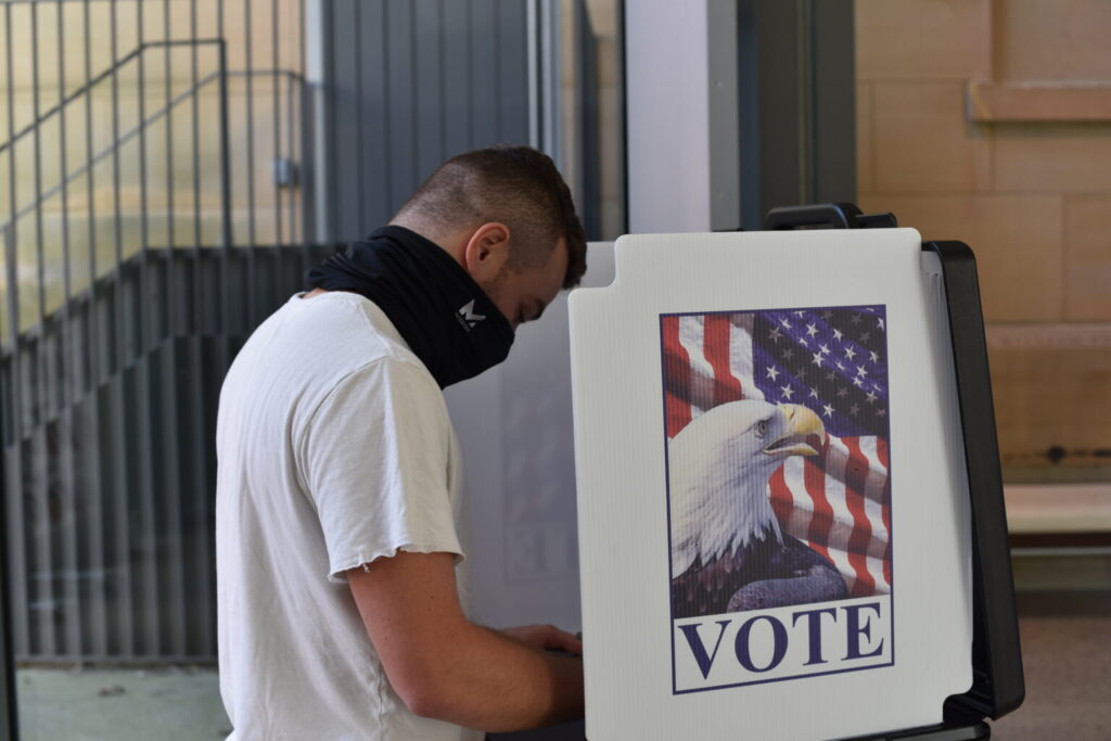 First-time voter Riley Freedman casts his vote at UMMA in October 2020.