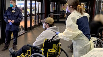 Nurse wheels patient to exit at U-M Hospital