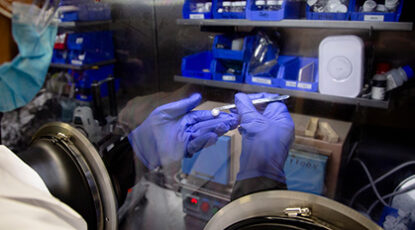 Scientist holds battery cell