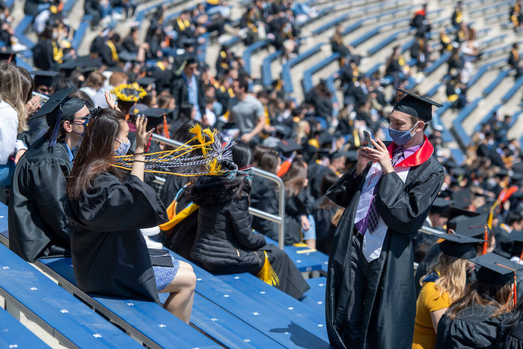 Grads take photos at Michigan Stadium