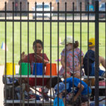 Kids watch the MMB practice at Elbel Field