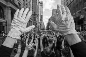 People raise hands in the streets of NYC,