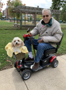 Man on scooter with dog