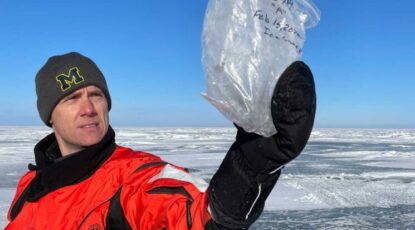 Scientist examines ice