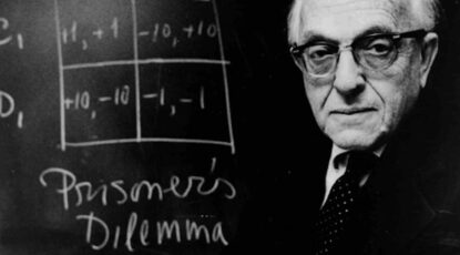 Anatol Rapoport at chalkboard featuring diagram of Prisoner's Dilemma