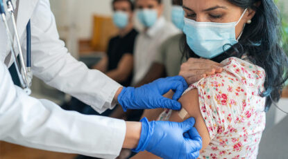 Doc puts bandaid on patient after vaccine