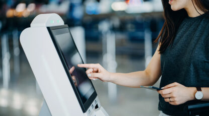 Woman uses touch screen at retail