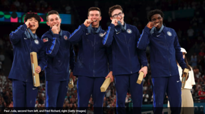 The US Men's Gymnastics team at Paris 2024 Olympics pose with the bronze medals they won on July 29. U-M's Paul Juda is second from left in the group of five athletes dressed in blue athletics wear. Fred Richard is on the far right.