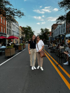 Two women stand on Main Street in Ann Arbor.