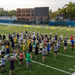 Michigan Marching Band members line up in formation.