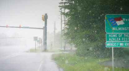 An image of a road in Wilmington, NC, under heavy rains.