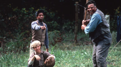 James Earl Jones on the set of Matewan, directed by John Sayles. He is holding a baseball bat and waiting for a pitch.