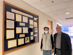 Two U-M scholars pose with Kopelman Research Poster at the Chemistry Building, 2023.