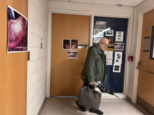 Panos Argryakis, a male professor who graduated from U-M in 1979, closes the door and exits the office of his mentor Raoul Kopelman.