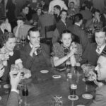 Group of caucasian students gather at the Pretzel Bell for drinks in 1937.