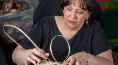 Woman weaves basket