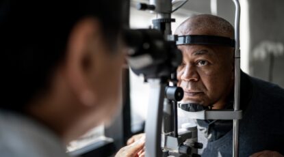 Man in optometrist's office undergoes glaucoma test.