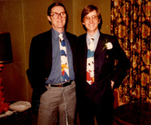 Father and son display funny ties under formal suits. Donald Duck and Mickey Mouse.