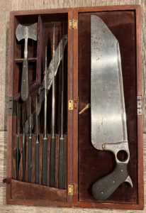 A replica of a Civil-War-era medical kit, including hack saw and other metal tools that look horrifying.