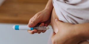 Person injects their own abdomen with a weight-loss drug, semaglutide, like Ozempic or Wegovy.