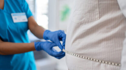 Doctor measures a person's girth using a measuring tape to determine if the person is a candidate for weight-loss drugs like Ozempic and Wegovy.