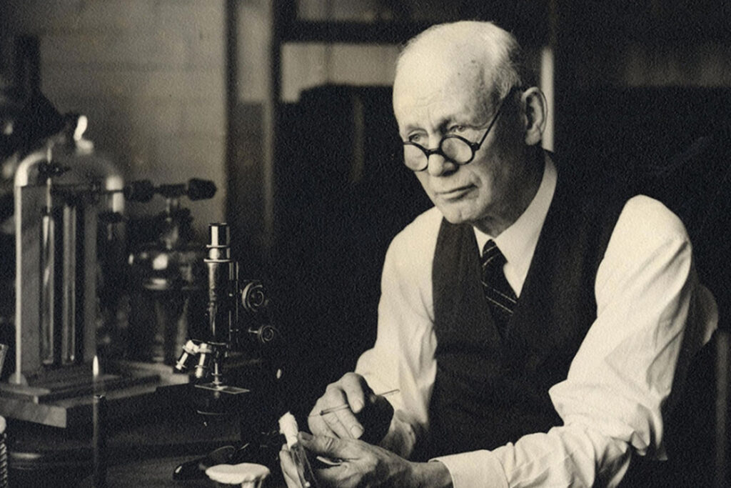 A caucasian man in sepia tones sits in a medical laboratory at the University of Michigan