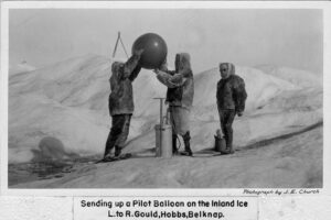 University of Michigan scientists of the 1920s prepare a weather balloon for an ascent from Greenland’s inland ice. Black & white.