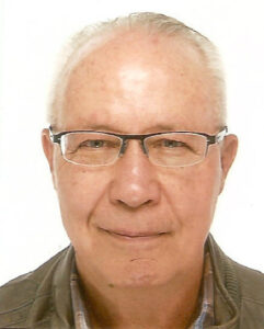 Headshot of James Barnes, Native American man, white hair, glasses.