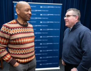 Branford Marsalis speaks to a fan after a lecture agt the Ford School. Two men, smiling, laughing.