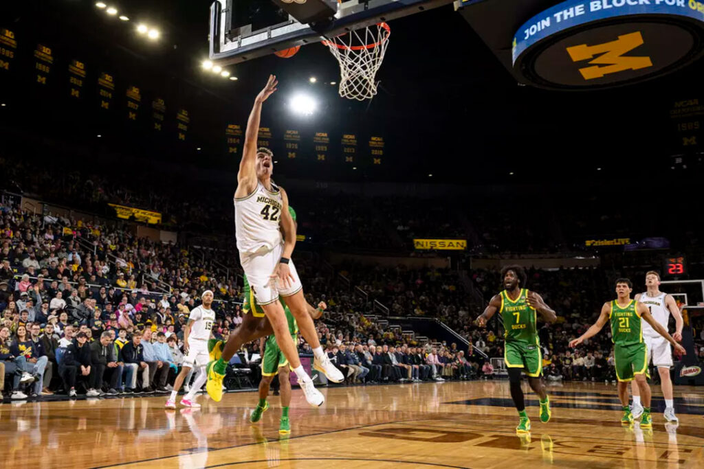 Michigan basketball player No. 42 Will Tschetter scores against Oregon.