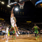 Michigan basketball player No. 42 Will Tschetter scores against Oregon.