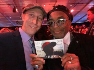 Davy Rothbart and director Spike Lee stand together at a film festival. Both are wearing caps.