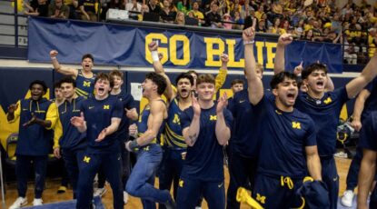 University of Michigan gymnastics team celebrates a victory.