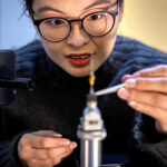 University of Michigan scientist carefully positions a metal sample for measurement.