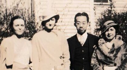 Sepia photo, dated 1933, of three caucasian women and one Asian man standing in a row. Women are dressed in period clothing. Cloche hats, etc.