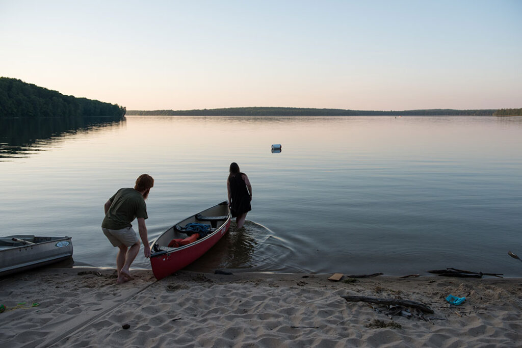 Two people take a rowboat into a Douglas Lake in Pellston, Michigan, for a moonlight experience.