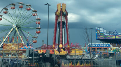 Image of a carnival under a stormy sky at Iggy Pop's high school, Pioneer, in Ann Arbor, Michigan