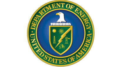Seal of the Department of Energy of the United States of America features a blue circle with an eagle and some other symbology surrounded by a green ring and gold lettering.