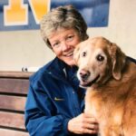 Softball Coach Carol Hutchins with her dog, Marley. Photo courtesy: @UMCoachHutch on X